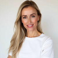 Caitlin Krumm woman with long blonde hair wearing a white t-shirt against a plain background